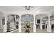 Elegant foyer with tile floors, grand staircase, soaring ceilings, and ornate columns at 10580 Poughkeepsie Cir, Port Charlotte, FL 33981
