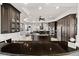 Gourmet kitchen with granite countertops, stainless steel appliances, and custom dark wood cabinetry at 10580 Poughkeepsie Cir, Port Charlotte, FL 33981