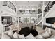 Spacious living room featuring a staircase, high ceilings, custom lighting, and luxurious seating at 10580 Poughkeepsie Cir, Port Charlotte, FL 33981