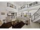 Expansive open-concept living room with dark wood accents, tile floors, and luxe furnishings at 10580 Poughkeepsie Cir, Port Charlotte, FL 33981