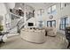Bright and open-concept living room with staircase, tall windows, and modern furnishings at 10580 Poughkeepsie Cir, Port Charlotte, FL 33981