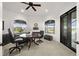 Bright office features a round desk, two large windows, and tile flooring at 10580 Poughkeepsie Cir, Port Charlotte, FL 33981