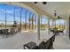 Covered and enclosed patio with waterfront views, comfortable seating, and ceiling fans at 10580 Poughkeepsie Cir, Port Charlotte, FL 33981