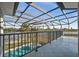 Enclosed patio area featuring a pool and lake view at 10580 Poughkeepsie Cir, Port Charlotte, FL 33981