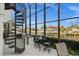 Outdoor patio with spiral staircase, grill, and waterfront views at 10580 Poughkeepsie Cir, Port Charlotte, FL 33981