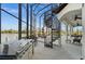 Large screened-in patio with outdoor kitchen, spiral staircase, and water views at 10580 Poughkeepsie Cir, Port Charlotte, FL 33981