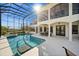 Enclosed pool area with a patio, outdoor seating and waterfront views at 10580 Poughkeepsie Cir, Port Charlotte, FL 33981