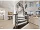 Elegant foyer featuring a curved staircase with dark wood treads and decorative iron railing, complemented by neutral decor at 10580 Poughkeepsie Cir, Port Charlotte, FL 33981