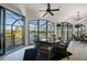 Enclosed sunroom with expansive windows offering water views and comfortable seating at 10580 Poughkeepsie Cir, Port Charlotte, FL 33981