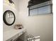 Bright vanity area with a round mirror, storage, and natural light at 10580 Poughkeepsie Cir, Port Charlotte, FL 33981