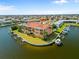 Aerial view of waterfront complex with boat docks, a pool, and lush landscaping at 1326 Wesley Dr # 132, Punta Gorda, FL 33950