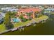 Beautiful waterfront condos featuring private boat slips and a community pool surrounded by palm trees at 1326 Wesley Dr # 132, Punta Gorda, FL 33950