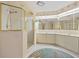 Bright bathroom features a glass shower, tiled floor and stylish mirror and vanity at 1326 Wesley Dr # 132, Punta Gorda, FL 33950
