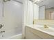 Bathroom featuring a tub with shower, tile surround, and bright vanity at 1326 Wesley Dr # 132, Punta Gorda, FL 33950