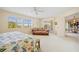 Bedroom features comfortable seating, a ceiling fan, large windows, and an adjoining balcony at 1326 Wesley Dr # 132, Punta Gorda, FL 33950