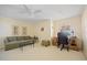 Comfortable bedroom featuring carpeted floor, ceiling fan, and a well-lit desk area at 1326 Wesley Dr # 132, Punta Gorda, FL 33950