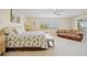 Inviting bedroom with a large bed, sitting area, ceiling fan, and natural light at 1326 Wesley Dr # 132, Punta Gorda, FL 33950