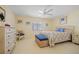 Cozy bedroom with a ceiling fan, nautical decor, and a bright window at 1326 Wesley Dr # 132, Punta Gorda, FL 33950