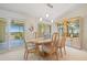 Bright dining room with an oval table, six chairs, and sliding glass doors to a balcony at 1326 Wesley Dr # 132, Punta Gorda, FL 33950
