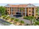 Beautiful condo building showcasing a private driveway, tropical landscaping, and balconies for each unit at 1326 Wesley Dr # 132, Punta Gorda, FL 33950