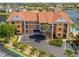 Well maintained condo building with a vibrant red-tile roof, lush landscaping, and plentiful parking at 1326 Wesley Dr # 132, Punta Gorda, FL 33950