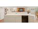 Kitchen with stainless-steel dishwasher, white cabinetry, and open access to living spaces at 1326 Wesley Dr # 132, Punta Gorda, FL 33950