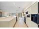 Spacious kitchen with stone countertops, stainless-steel appliances, and open dining and living area at 1326 Wesley Dr # 132, Punta Gorda, FL 33950