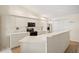 Bright kitchen with white cabinetry, quartz countertops, and stainless-steel appliances at 1326 Wesley Dr # 132, Punta Gorda, FL 33950