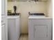 Laundry room featuring a stacked washer and dryer with overhead storage at 1326 Wesley Dr # 132, Punta Gorda, FL 33950
