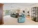 Open-concept living space with ceiling fan, slider doors, and neutral carpet at 1326 Wesley Dr # 132, Punta Gorda, FL 33950