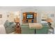 Inviting living area with a large TV, comfortable seating, and views into the bedroom at 1326 Wesley Dr # 132, Punta Gorda, FL 33950