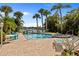 Inviting pool and spa area with tropical landscaping, lounge chairs, and views of the surrounding neighborhood at 1326 Wesley Dr # 132, Punta Gorda, FL 33950