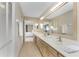 Bathroom featuring a long countertop with double sinks, neutral walls, tile flooring and an attached bedroom at 1750 Jamaica Way # 312, Punta Gorda, FL 33950