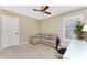 Cozy bedroom with a ceiling fan and a comfortable sofa at 1750 Jamaica Way # 312, Punta Gorda, FL 33950