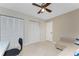 Bedroom featuring double closets, a ceiling fan and sofa at 1750 Jamaica Way # 312, Punta Gorda, FL 33950