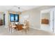Bright dining area with modern light fixture and water views from expansive window at 1750 Jamaica Way # 312, Punta Gorda, FL 33950