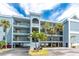 Condo building exterior with balconies and tropical landscaping at 1750 Jamaica Way # 312, Punta Gorda, FL 33950