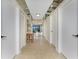 Hallway with a mirrored ceiling, showcasing doorways and water views at the far end at 1750 Jamaica Way # 312, Punta Gorda, FL 33950