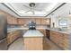 Functional kitchen with a center island, light wood cabinetry, and modern stainless steel appliances at 1750 Jamaica Way # 312, Punta Gorda, FL 33950