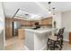 Open kitchen features a breakfast bar with seating, stainless steel refrigerator, and modern appliances at 1750 Jamaica Way # 312, Punta Gorda, FL 33950