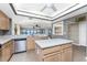 Bright kitchen features granite countertops, stainless appliances, and views to the water and breakfast room at 1750 Jamaica Way # 312, Punta Gorda, FL 33950