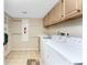 Laundry room featuring tile flooring, neutral walls, white washer and dryer, and built in cabinets at 1750 Jamaica Way # 312, Punta Gorda, FL 33950