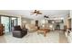 Spacious living room with plush seating and natural light, seamlessly connecting to the dining and kitchen areas at 1750 Jamaica Way # 312, Punta Gorda, FL 33950