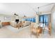 Bright and airy living room with tile floors and stunning waterfront views through large windows at 1750 Jamaica Way # 312, Punta Gorda, FL 33950