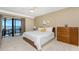 Bedroom with natural light has access to a balcony with a scenic waterfront view at 1750 Jamaica Way # 312, Punta Gorda, FL 33950