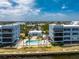 A pool and outdoor area sit between waterfront condo buildings at 1750 Jamaica Way # 312, Punta Gorda, FL 33950