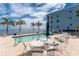 Enjoy poolside lounging with tables and chairs overlooking scenic water views at 1750 Jamaica Way # 312, Punta Gorda, FL 33950