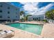 Relaxing community pool area with lounge chairs and seating under sunny skies at 1750 Jamaica Way # 312, Punta Gorda, FL 33950