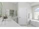 Luxurious bathroom with a soaking tub, double vanity, and modern fixtures at 18652 Ohara Dr, Port Charlotte, FL 33948