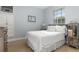 Bright bedroom featuring blue walls, large window and minimalist decor at 18652 Ohara Dr, Port Charlotte, FL 33948